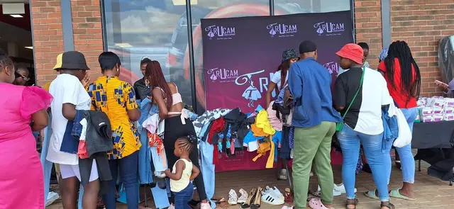 Community members choosing donated clothes at the Joyful Hearts Drive