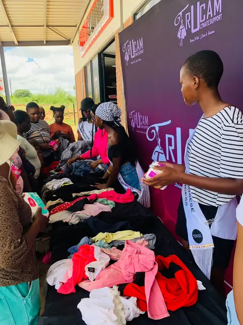 A community member receiving clothes at the Joyful Hearts Drive